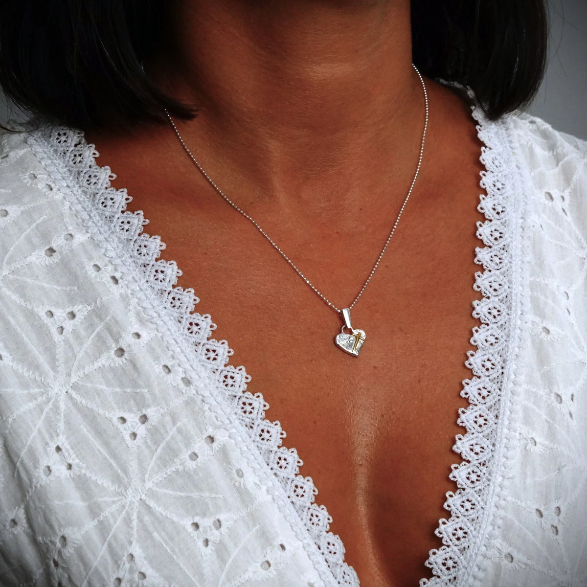 „Glaube an die Liebe“-Miniaturanhänger mit Herz und Kreuz aus 925er Silber mit vergoldeten Akzenten – handgefertigtes Symbol spiritueller Liebe, rustikaler Skulpturenschmuck aus der Kollektion „Glanz“ | Art Diva