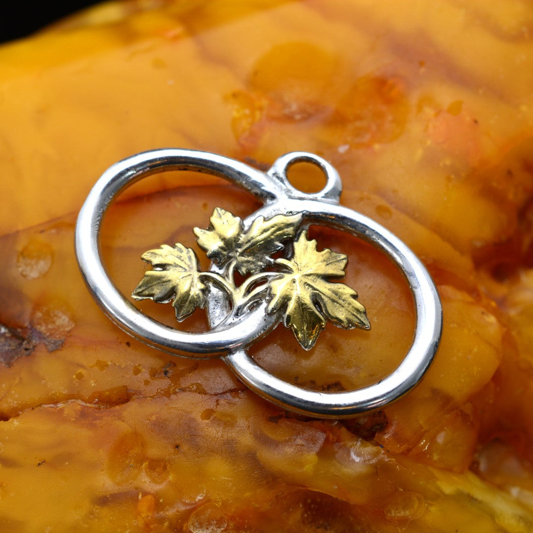 „Zwei Ringe mit Weinblättern“-Anhänger aus 925er Silber mit goldenen Akzenten – handgefertigter Talisman für Verbundenheit und Wachstum, skulpturaler Schmuck im Boho-Rustik-Stil | Art Diva